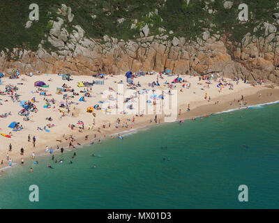 Beach at Pothcurno Bay / Cove in Cornwall, England, UK, showing the beach on a summer day. Aerial shot of holidaymakers sunbathing and swimming. Stock Photo