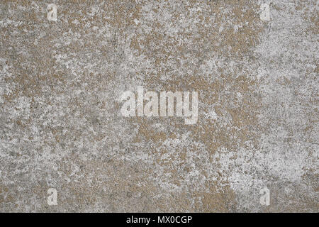 weathered concrete stone wall background texture pattern with white paint mostly peeled off Stock Photo