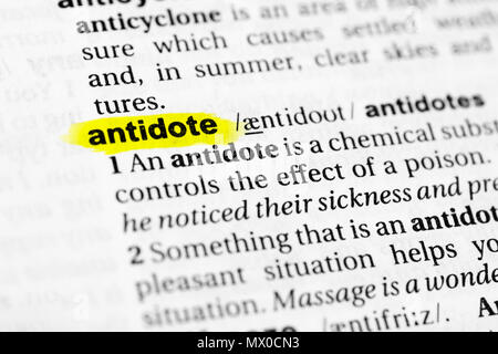 Highlighted English word 'antidote' and its definition in the dictionary. Stock Photo