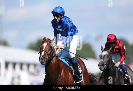 Masar ridden by jockey William Buick coming home to win the Investec Derby during derby day of the 2018 Investec Derby Festival at Epsom Downs Racecourse. Stock Photo