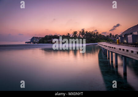 Amazing purple sky and Indian ocean at sunrise in Maldives Stock Photo