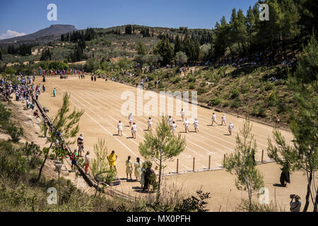 Runners race in the ancient stadium at Nemea, Greece, on June 11, 2016. Stock Photo