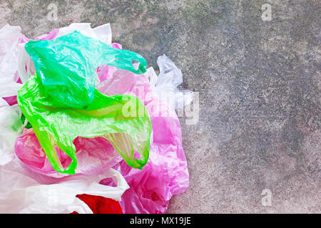 Colorful plastic bag on cement floor background. Stock Photo