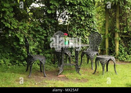 Wrought iron garden table and chairs Stock Photo