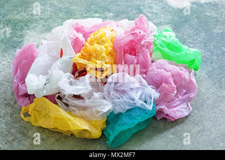 Colorful plastic bag on cement floor background. Stock Photo