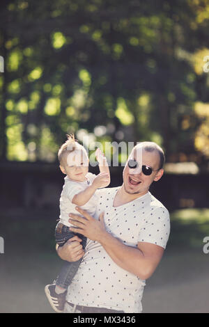 happy father with son playing in park Stock Photo