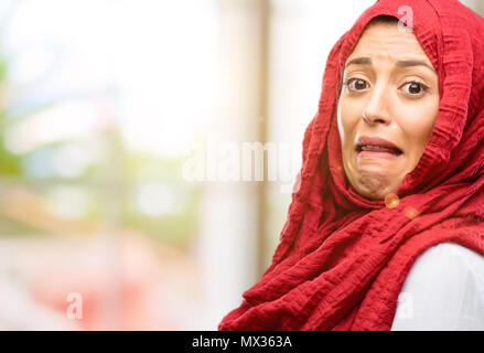 Young arab woman wearing hijab feeling disgusted with tongue out Stock Photo