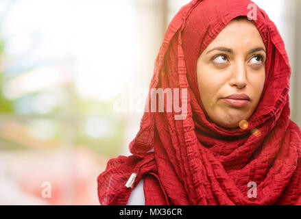 Young arab woman wearing hijab making funny face fooling Stock Photo