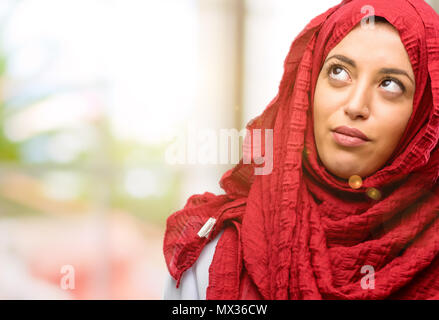 Young arab woman wearing hijab making funny face fooling Stock Photo
