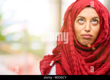 Young arab woman wearing hijab making funny face fooling Stock Photo