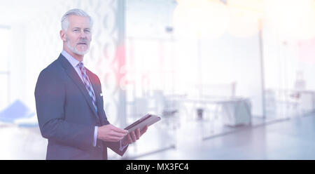 Portrait of senior businessman using tablet in front of his modern office Stock Photo