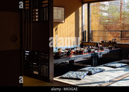 A lot of plates are placed on the table. Beautiful day view with shadows. In a Japanese restaurant. at Tokyo Japan Stock Photo