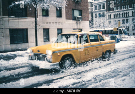 1995, One of the Few Remaining Checker Taxi Cabs Plows though a Snowy New York City Street, NYC, USA Stock Photo