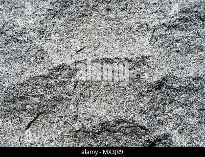 Background texture of gray and black uneven rock surface contours. Stock Photo