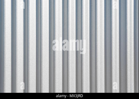 Background texture of clean wavy corrugated vertical metal siding. Stock Photo