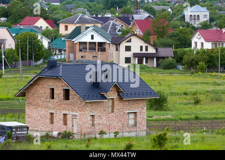 Aerial view of a new modern residential house under construction. Real estate development concept. Private home with metal roofing. Stock Photo