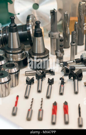 New saws and drills on the stand. New modern industrial drills and mills of the different sizes. Small depth of sharpness. Stock Photo