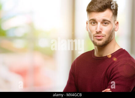 Handsome young man expressing love, blows kiss at camera, flirting Stock Photo