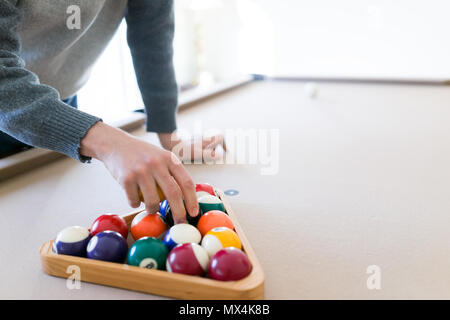 Interior house home with billiard pool table in living room, order of 15 balls inside triangle rack, setting up eight ball game Stock Photo