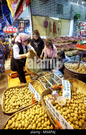 Xian, China - October 5, 2017: Street market in the Muslim Quarter, well-known tourism site famous for its culture and food. Stock Photo