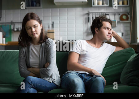 Unhappy millennial couple ignoring each other not talking after  Stock Photo