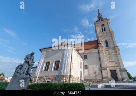 Slovenska Bistrica, Slovenia, June 2 2018: Church tower with clock of St. Bartholomew's church in Slovenska Bistrica, Slovenia with statue of very imp Stock Photo