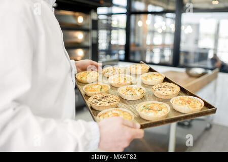 Holding tray with freshly baked buns Stock Photo