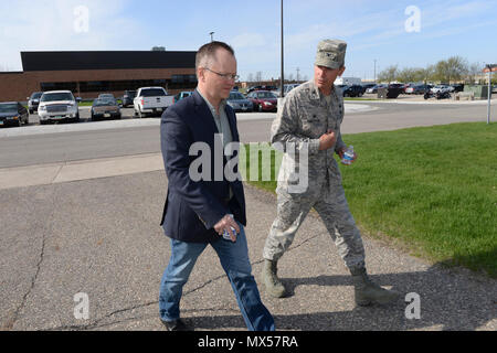 Col. Darrin Anderson, the 119th Intelligence Surveillance Reconnaissance Group Commander, right, leads North Dakota Lt. Gov. Brent Sanford, on an organizational base tour at the North Dakota Air National Guard Base, Fargo, N.D., May 2, 2017. Stock Photo