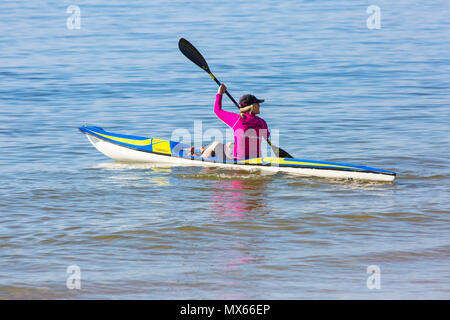 Branksome Chine, Poole, Dorset, UK. 3rd June 2018. UK weather: a lovely warm sunny start to the day, as visitors head to the seaside. Young woman enjoying being on the sea in a surf ski. Credit: Carolyn Jenkins/Alamy Live News Stock Photo