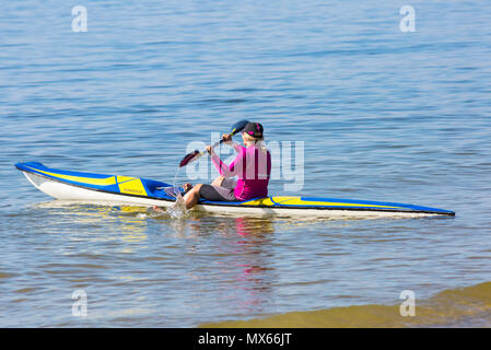 Branksome Chine, Poole, Dorset, UK. 3rd June 2018. UK weather: a lovely warm sunny start to the day, as visitors head to the seaside. Young woman enjoying being on the sea in a surf ski. Credit: Carolyn Jenkins/Alamy Live News Stock Photo