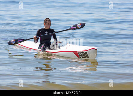 Branksome Chine, Poole, Dorset, UK. 3rd June 2018. UK weather: a lovely warm sunny start to the day, as visitors head to the seaside. Young woman enjoying being on the sea in a surf ski. Credit: Carolyn Jenkins/Alamy Live News Stock Photo