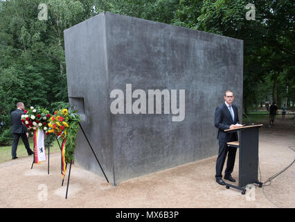 03 June 2018, Berlin, Germany: Michael Mueller (SPD), Governing Mayor of Berlin, speaks during a ceremony in front of the monument to the homosexuals persecuted under National Socialism in the Tiergarten. Photo: Ralf Hirschberger/dpa Stock Photo