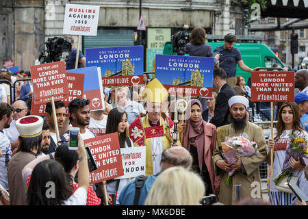 London Bridge, Southwark, London, 3rd June 2018. The Bishop of Southwark,The Rt Revd Christopher Chessun, with a Muslim cleric and members of the public. Following a service at Southwark Cathedral commemorating the first anniversary of the London Bridge terror attack, those who died or were harmed in the attack are remembered by a procession, flower laying and a minute’s silence at London Bridge in Southwark. Credit: Imageplotter News and Sports/Alamy Live News Stock Photo