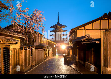 Japanese pagoda and old house with cherry blossom in Kyoto at twilight. Stock Photo