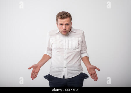 stressed caucasian young man showing empty pockets. Concept of no money. Stock Photo