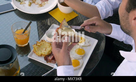 Breakfast with eggs bread and orange juice and a little bit butter Stock Photo