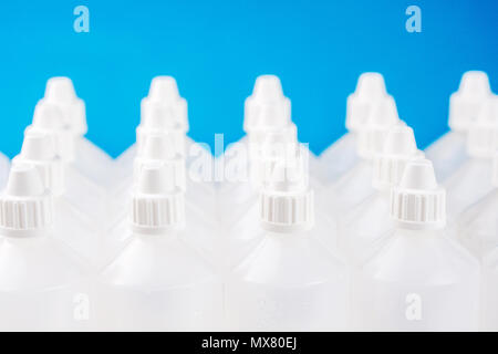 white translucent bottles used in homeopathy on blue and blurred bottles background Stock Photo