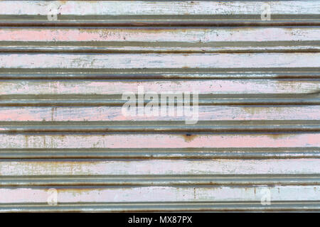 metal fence made of corrugated steel sheet with vertical guides Stock Photo