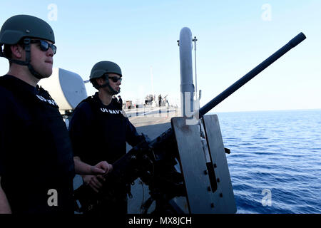 SOUDA BAY, Greece (May 3, 2017) – Gunner’s Mate 2nd Class Caleb Samples, from Greenville, Texas, left, and Fire Controlman 2nd Class Devin Davis, from Hollywood, Florida, stand small craft action team watch aboard the Arleigh Burke-class guided-missile destroyer USS Oscar Austin (DDG 79) as the ship departs Souda Bay, Greece, after a scheduled port visit May 3, 2017. Oscar Austin is on a routine deployment supporting U.S. national security interests in Europe, and increasing theatre security cooperation and forward naval presence in the U.S. 6th Fleet area of operations. Stock Photo