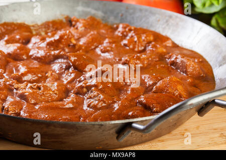 Chicken tikka masala. Traditional Asian spicy meat served with rice or bread naan on a frying pan Stock Photo