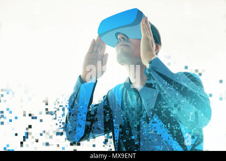 A person in virtual reality glasses is fragmented into pixels. The concept of modern technologies and technologies of the future. VR glasses Stock Photo