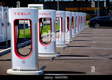 Tesla multi electric car charging points at French service station Stock Photo