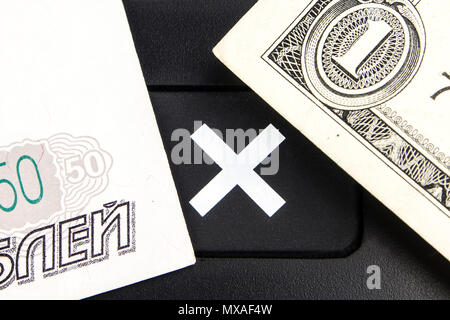 banknotes of one american dollar and russian ruble are laying on black multiplication button Stock Photo