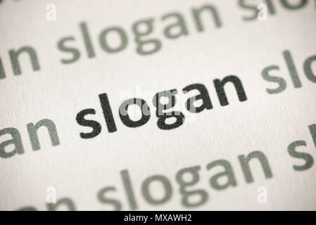 word slogan printed on white paper macro Stock Photo