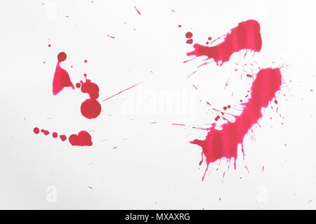 Red ink splash isolated on white cotton paper. Design element. Stock Photo