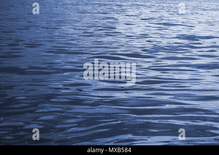 Water surface with waves, abstract, slightly defocused blue water background Stock Photo