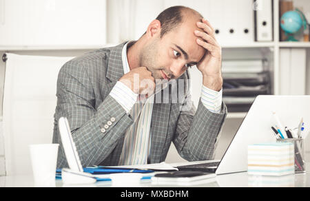 Male having lot of work and problems in the office Stock Photo