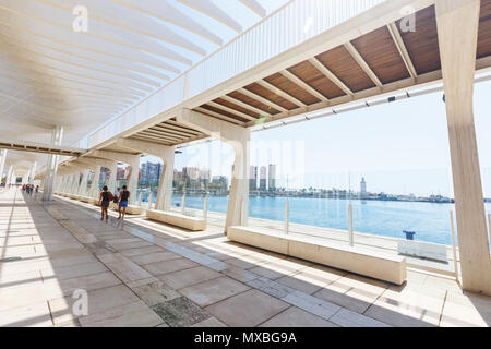 Malaga, Spain - September 8, 2015: People walk under the designer sunshade runnind wave in sunny autumn day Stock Photo