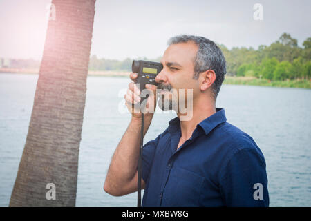 Man with old vintage camera in hands. Stock Photo