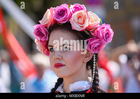 Lowicz / Poland - May 31.2018: Portrait of a woman dressed in a colorful folklore, regional costume with flower wreath on the head during Corpus Chris Stock Photo